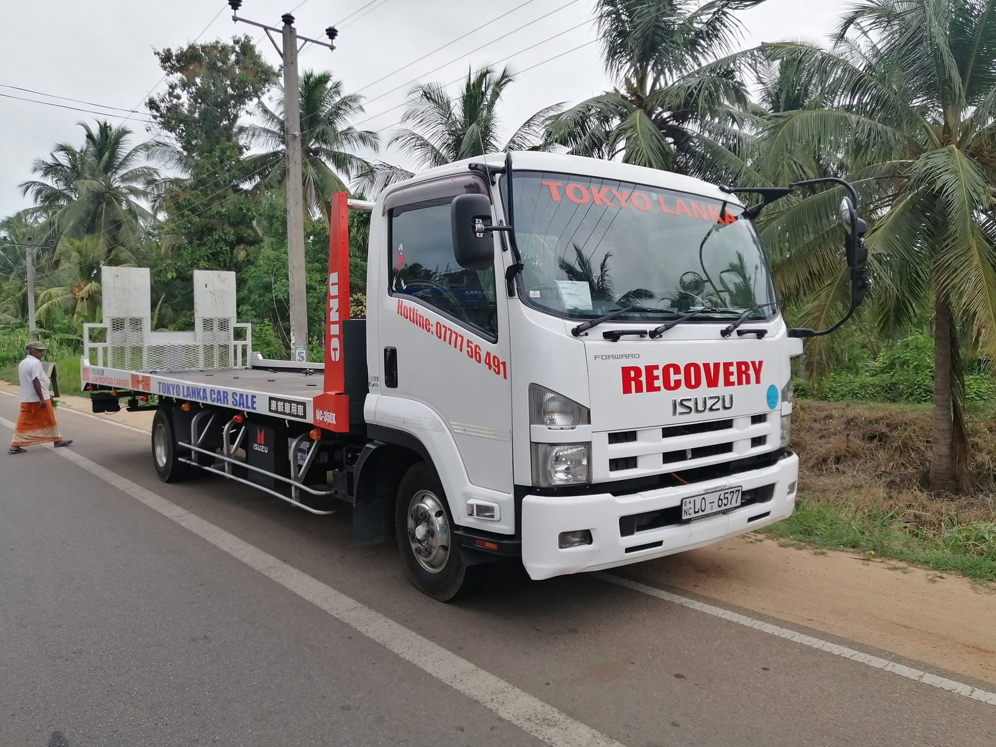 Tokyo Lanka white Isuzu flatbed recovery carrier
